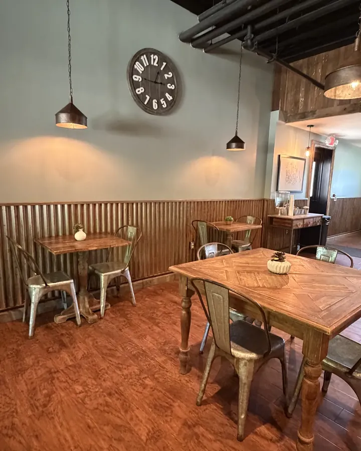 Seating in the coffee & tea bar at Timber Wolf Lake, Michigan: wood tables, metal chairs and pendant lights