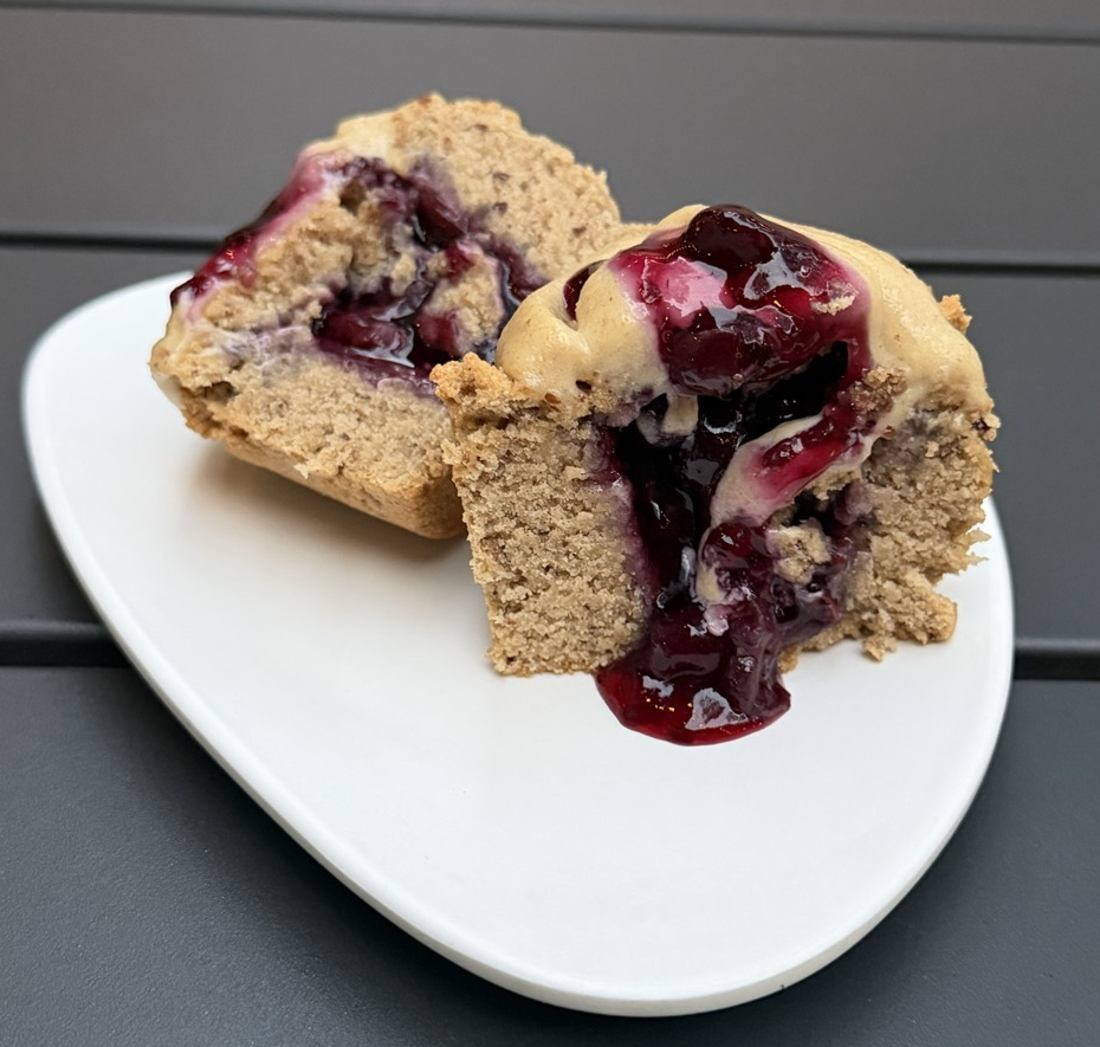 Warm cupcake with berry sauce oozing out