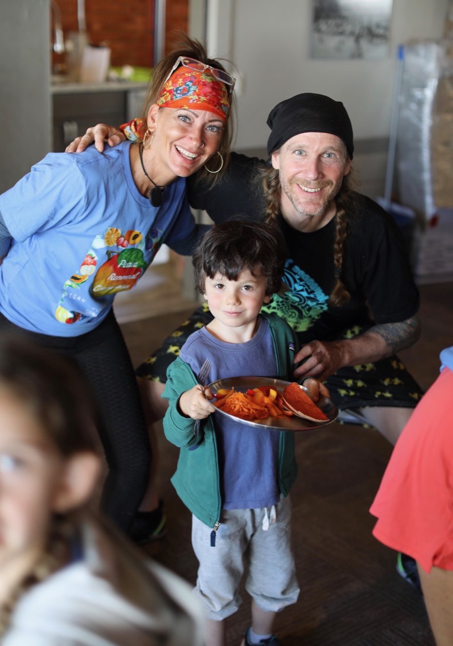 A child holding a plate of plant-based food at the VWR Kids Club
