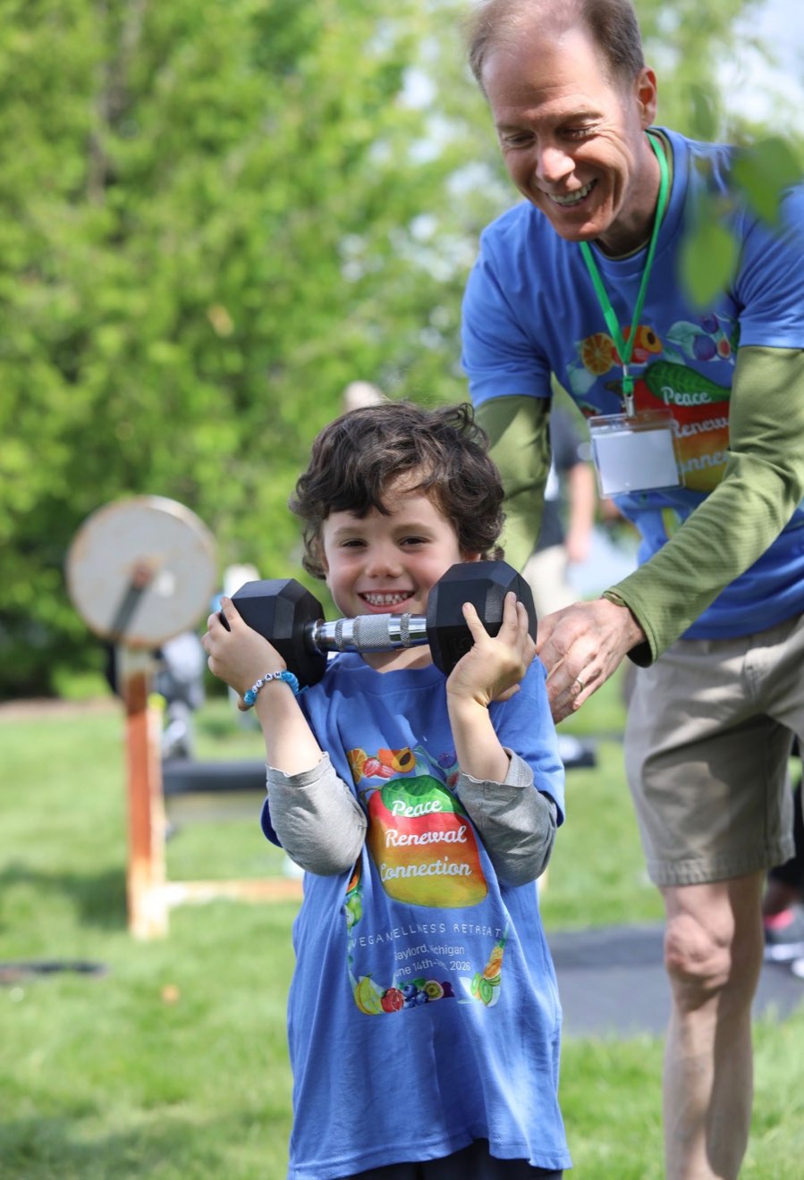 A young boy lifting light dumbbells at the retreat
