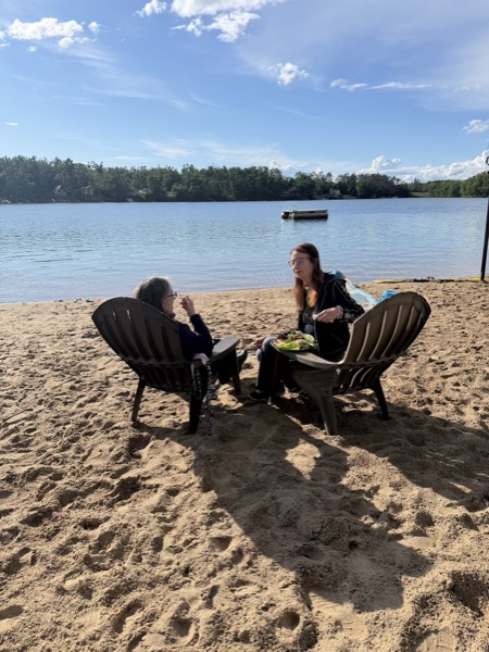 Vegan Wellness Retreats — guests relaxing lakeside in Adirondack chairs