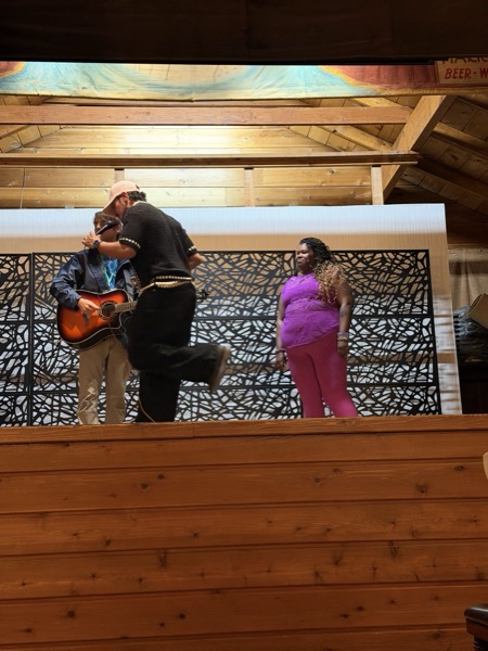 Vegan Wellness Retreats — a guest playing guitar at the talent show