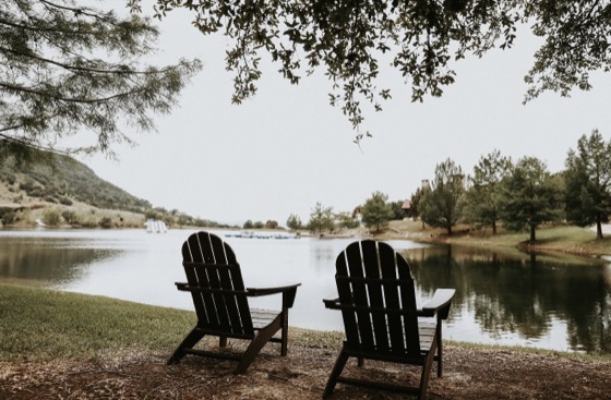 Adirondack chairs overlooking the lake at LoneHollow Ranch, Texas