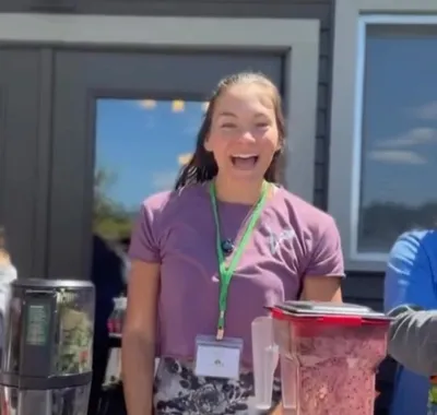 A smiling guest at the Triple Bar smoothie station